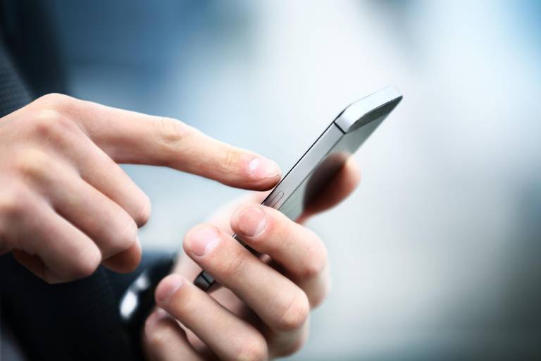 Close up of a man using mobile smart phone calling